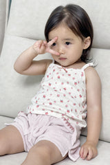 Toddler girl sitting on sofa wearing Avauma Pocket Day Shorts in Milk Pink with floral top
Toddler girl sitting on sofa wearing Avauma Pocket Day Shorts in Milk Pink with floral top