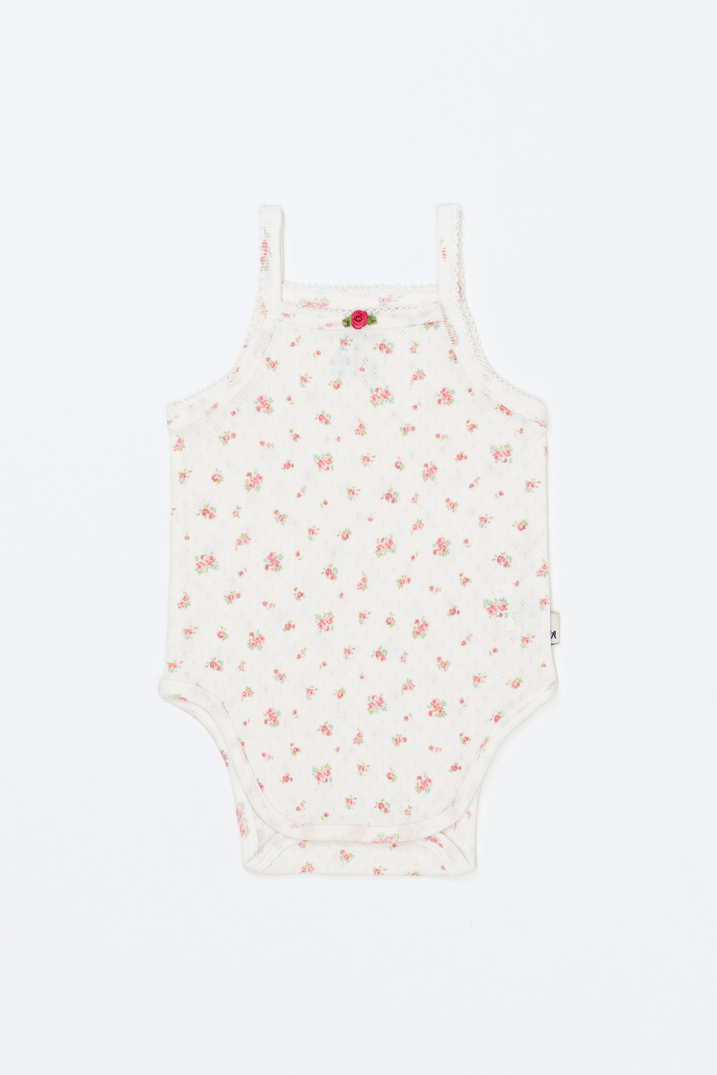 Avauma Summer Picot Sleeveless Bodysuit Rosebell product shot. Lay-flat of white baby romper with delicate pink floral pattern on white background.
Avauma Summer Picot Sleeveless Bodysuit Rosebell product shot. Lay-flat of white baby romper with delicate pink floral pattern on white background.