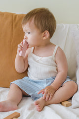 Toddler sitting in Avauma Sunny Stripe Pants Blueberry Powder. Child playing with blocks, wearing light blue striped shorts and a white top.
 Toddler sitting in Avauma Sunny Stripe Pants Blueberry Powder. Child playing with blocks, wearing light blue striped shorts and a white top.