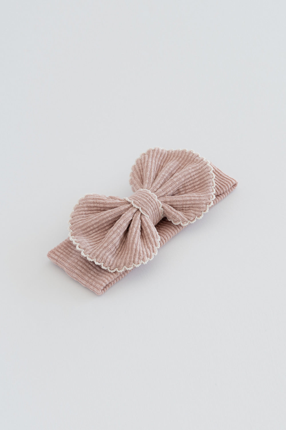Avauma Mellow Ribbon Band in Baby Blush – Flat lay of soft pink corduroy bow headband
 Avauma Mellow Ribbon Band in Baby Blush – Flat lay of soft pink corduroy bow headband