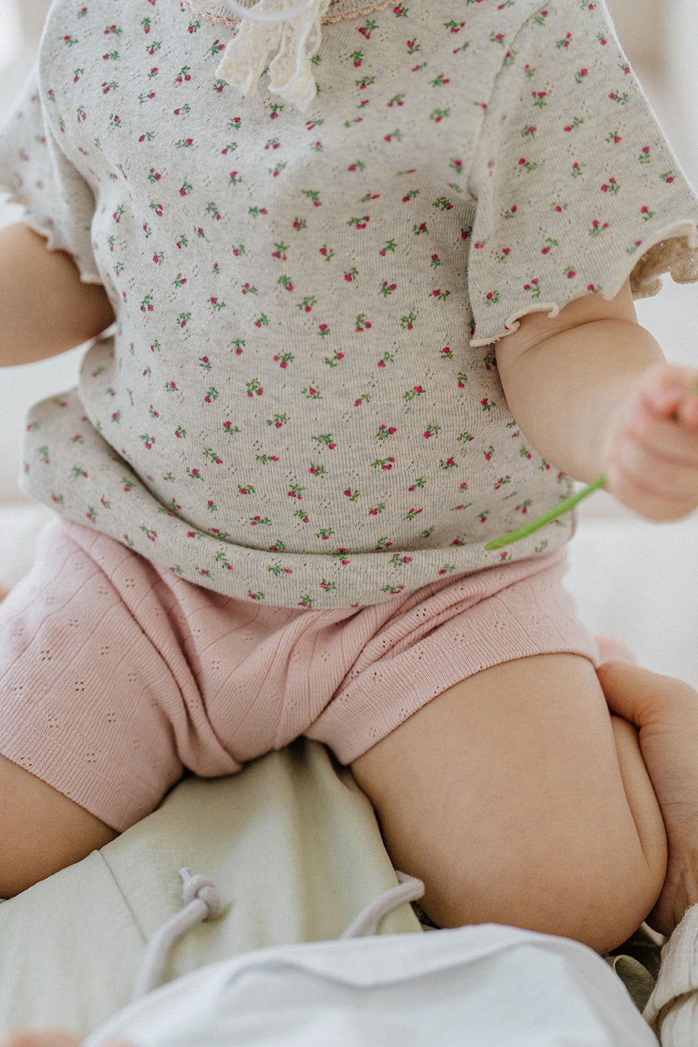 avauma breeze garden set oatberry cream, close-up of floral print baby shirt and pink cotton shorts, soft ribbed texture
avauma breeze garden set oatberry cream, close-up of floral print baby shirt and pink cotton shorts, soft ribbed texture