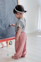 Toddler wearing Avauma Breeze Jogger Pants in rose wood, standing and drawing on chalkboard. Toddler wearing Avauma Breeze Jogger Pants in rose wood, standing and drawing on chalkboard.