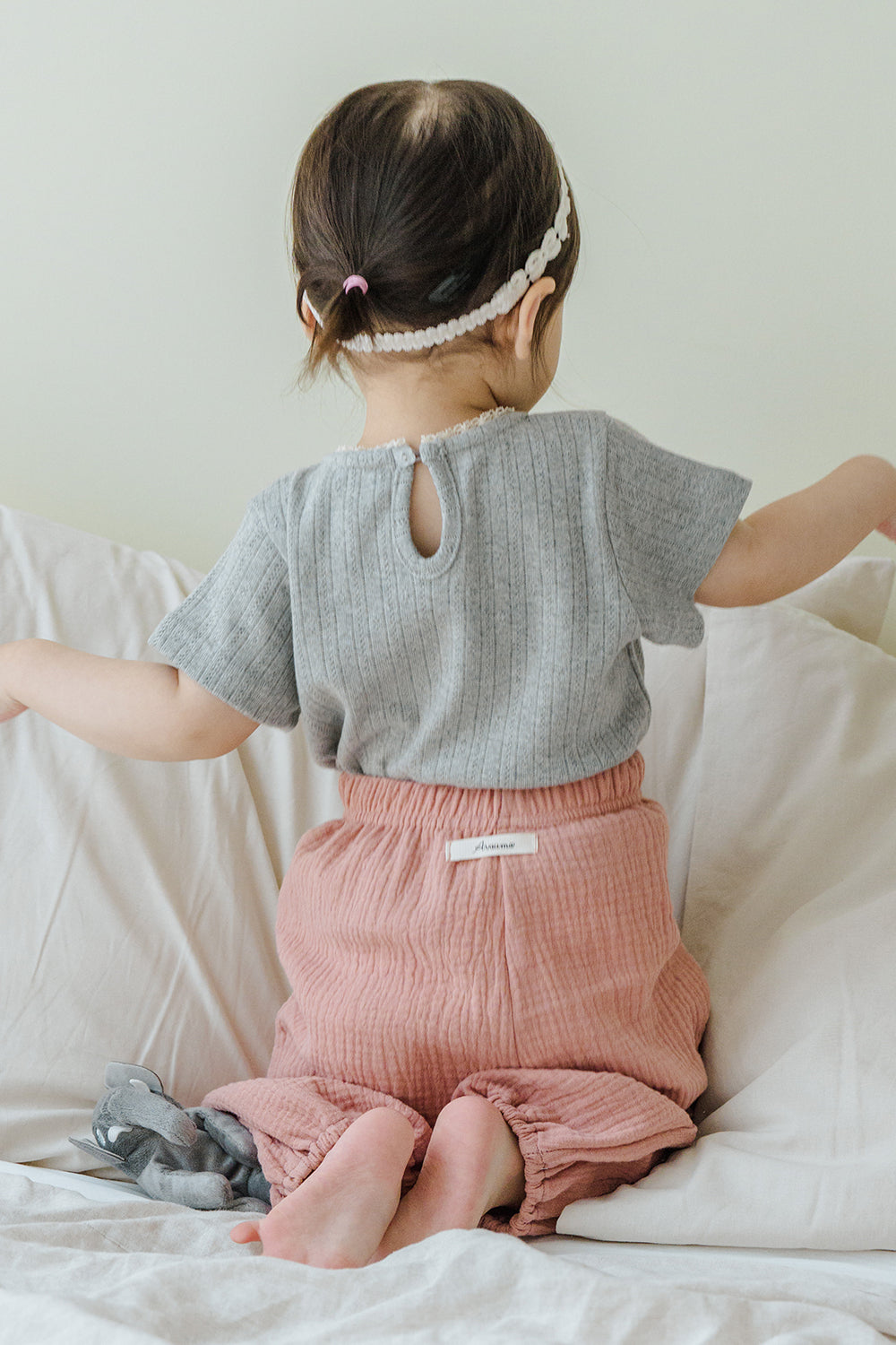 Back view of child wearing Avauma Breeze Jogger Pants in rose wood, showing elastic waistband. Back view of child wearing Avauma Breeze Jogger Pants in rose wood, showing elastic waistband.
