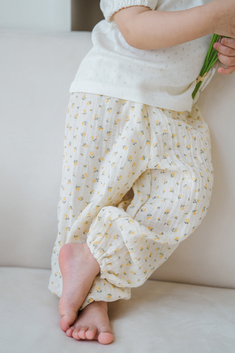 Close-up side view of Avauma Breeze Jogger Pants in yellow flower pattern, soft cotton fabric and loose fit. Close-up side view of Avauma Breeze Jogger Pants in yellow flower pattern, soft cotton fabric and loose fit.
