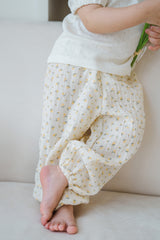 Close-up side view of Avauma Breeze Jogger Pants in yellow flower pattern, soft cotton fabric and loose fit. Close-up side view of Avauma Breeze Jogger Pants in yellow flower pattern, soft cotton fabric and loose fit.