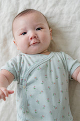 Close-up of Baby Wearing Avauma Clare Mint Rose Wrap-Style Short Sleeve Bodysuit, Soft and Gentle on Skin
Close-up of Baby Wearing Avauma Clare Mint Rose Wrap-Style Short Sleeve Bodysuit, Soft and Gentle on Skin