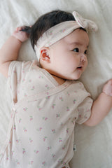 Side View of Baby Wearing Avauma Clare Peach Cream Short Sleeve Bodysuit, Delicate Floral Design
Side View of Baby Wearing Avauma Clare Peach Cream Short Sleeve Bodysuit, Delicate Floral Design