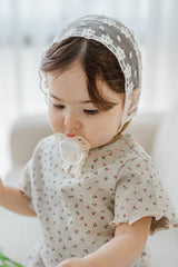 toddler girl with pacifier wearing avauma Clare Bonnet Ivory Race with floral outfit toddler girl with pacifier wearing avauma Clare Bonnet Ivory Race with floral outfit