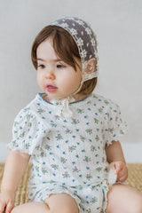 toddler wearing avauma Clare Bonnet Ivory Race with puff-sleeved floral romper toddler wearing avauma Clare Bonnet Ivory Race with puff-sleeved floral romper