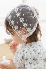 close-up side view of avauma Clare Bonnet Ivory Race showing floral lace detail on toddler close-up side view of avauma Clare Bonnet Ivory Race showing floral lace detail on toddler