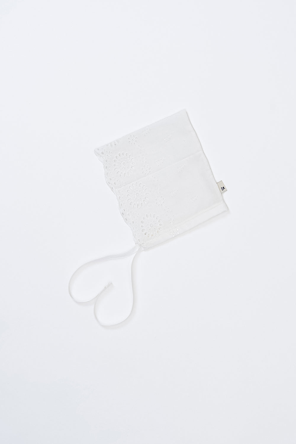 Avauma Clare Bonnet - Cotton Cream laid flat on white background, featuring floral punch lace and ribbon ties Avauma Clare Bonnet - Cotton Cream laid flat on white background, featuring floral punch lace and ribbon ties