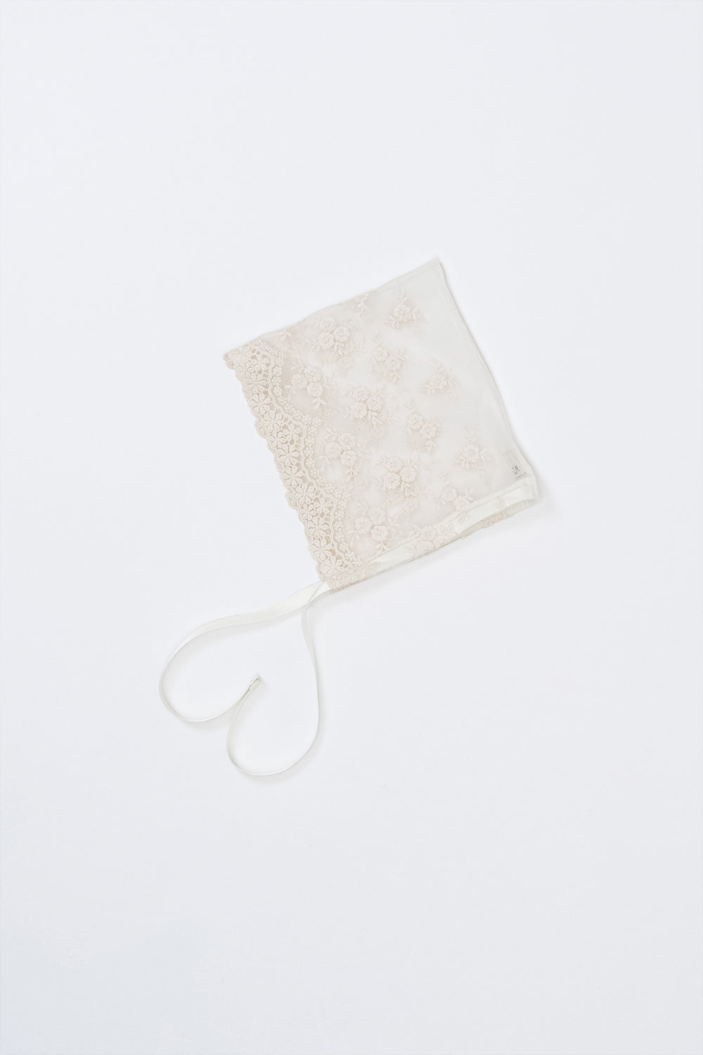 Avauma Clare Bonnet - Ivory Race, laid flat on white background to display floral embroidery and ribbon ties Avauma Clare Bonnet - Ivory Race, laid flat on white background to display floral embroidery and ribbon ties