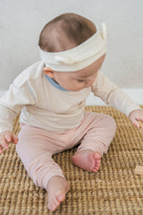 Baby girl wearing Avauma Vanilla Sky pajama set – comfortable ribbed cotton for infants Baby girl wearing Avauma Vanilla Sky pajama set – comfortable ribbed cotton for infants
