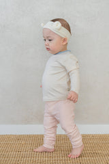Side view of toddler girl in Avauma Vanilla Sky baby pajamas – stretchy ribbed sleepwear  Side view of toddler girl in Avauma Vanilla Sky baby pajamas – stretchy ribbed sleepwear