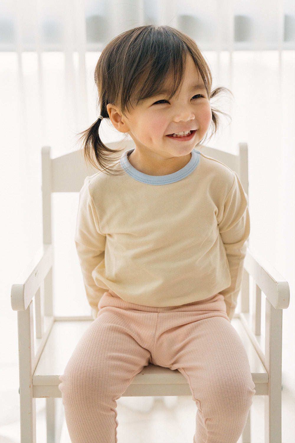 Toddler girl smiling in Avauma ribbed pajama set – breathable and soft baby sleepwear Toddler girl smiling in Avauma ribbed pajama set – breathable and soft baby sleepwear