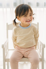 Toddler girl smiling in Avauma ribbed pajama set – breathable and soft baby sleepwear Toddler girl smiling in Avauma ribbed pajama set – breathable and soft baby sleepwear
