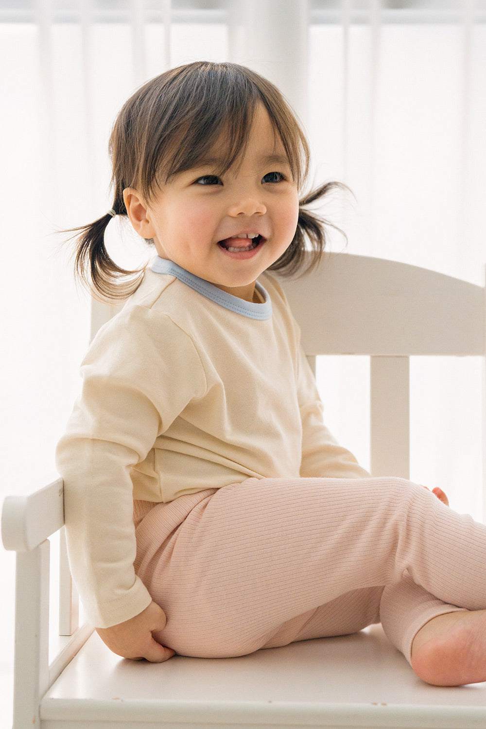 Toddler girl smiling in Avauma ribbed pajama set – breathable and soft baby sleepwear Toddler girl smiling in Avauma ribbed pajama set – breathable and soft baby sleepwear