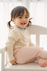 Toddler girl smiling in Avauma ribbed pajama set – breathable and soft baby sleepwear Toddler girl smiling in Avauma ribbed pajama set – breathable and soft baby sleepwear