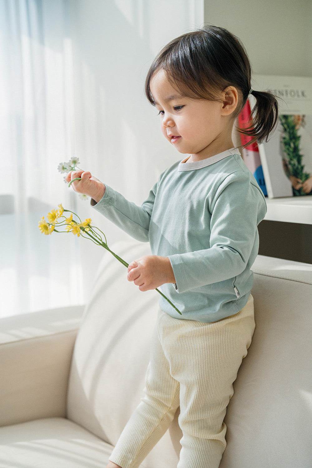 Child pairing a beige cardigan with the Avauma Cloud Ribbed Setup top in Sage Leaf – a versatile kids’ outfit suitable for both indoor and outdoor layering Child pairing a beige cardigan with the Avauma Cloud Ribbed Setup top in Sage Leaf – a versatile kids’ outfit suitable for both indoor and outdoor layering