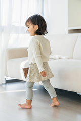 Back view of toddler girl walking in Avauma mint green skirted leggings with blue floral pattern Back view of toddler girl walking in Avauma mint green skirted leggings with blue floral pattern