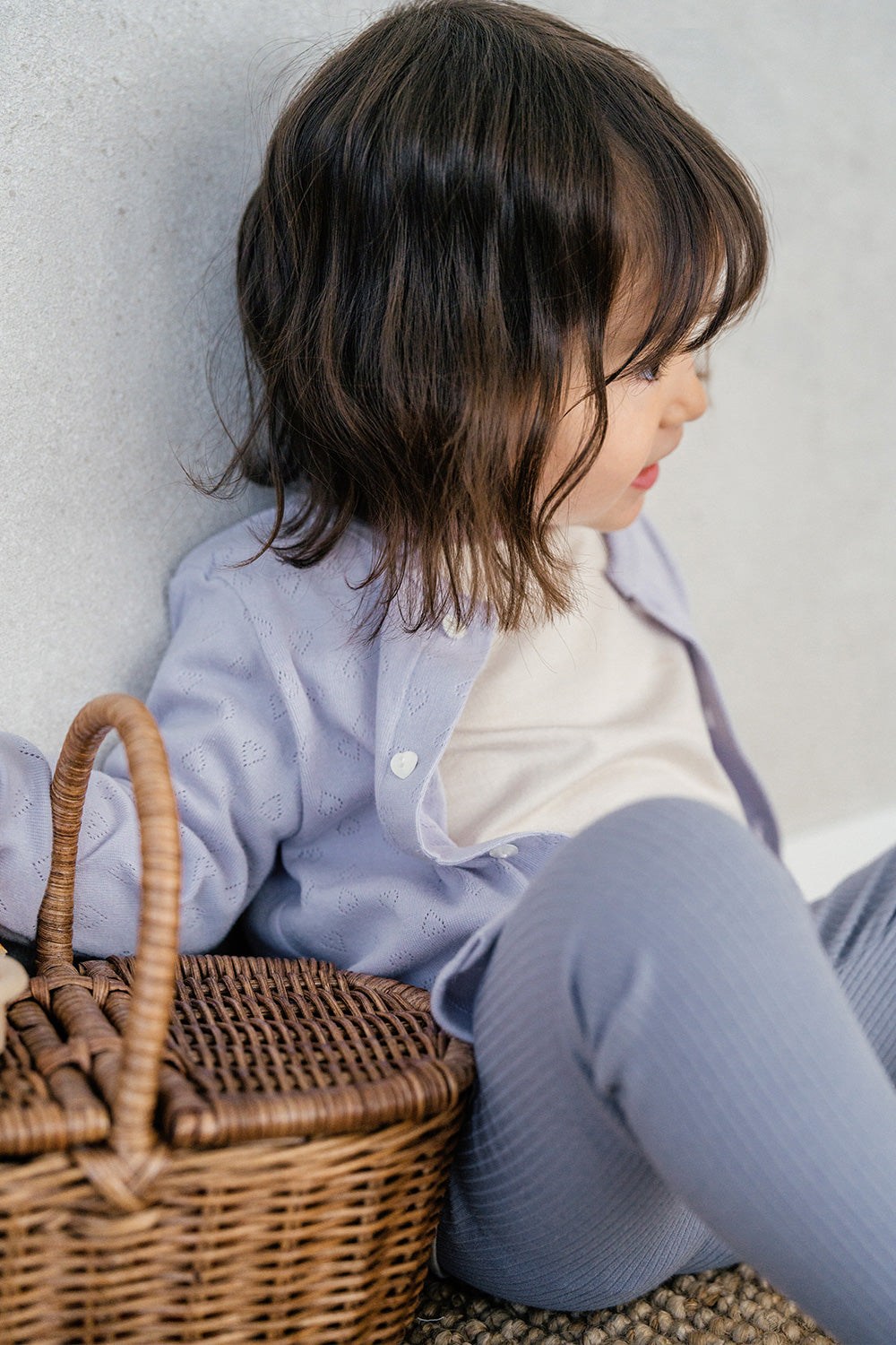 Close-up of Avauma Haze Heart Cardigan in Soft Plume, heart eyelet details on soft cotton fabric, ideal for layering. Close-up of Avauma Haze Heart Cardigan in Soft Plume, heart eyelet details on soft cotton fabric, ideal for layering.