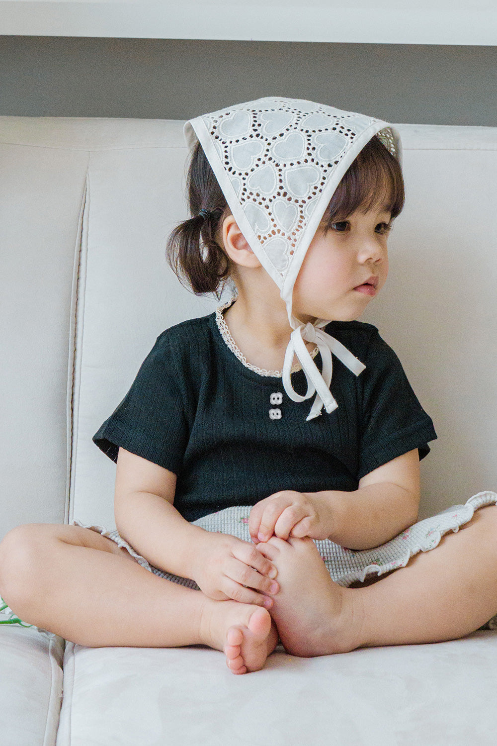 Toddler Sitting in Avauma Le Petite Classic Black Puff Sleeve T-Shirt, Stylish and Comfy Summer Top
 Toddler Sitting in Avauma Le Petite Classic Black Puff Sleeve T-Shirt, Stylish and Comfy Summer Top