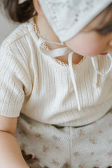 Close-up of Avauma Le Petite White Oat Puff Sleeve Knit T-Shirt, Lightweight Short Sleeve Babywear
Close-up of Avauma Le Petite White Oat Puff Sleeve Knit T-Shirt, Lightweight Short Sleeve Babywear