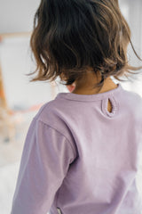 Close-up of back detail on Avauma Lavender Pale baby jogger set – soft cotton buttoned neckline
 Close-up of back detail on Avauma Lavender Pale baby jogger set – soft cotton buttoned neckline