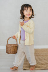 Toddler wearing Avauma Lavender Pale jogger set layered with yellow cardigan – comfy layered baby look
 Toddler wearing Avauma Lavender Pale jogger set layered with yellow cardigan – comfy layered baby look