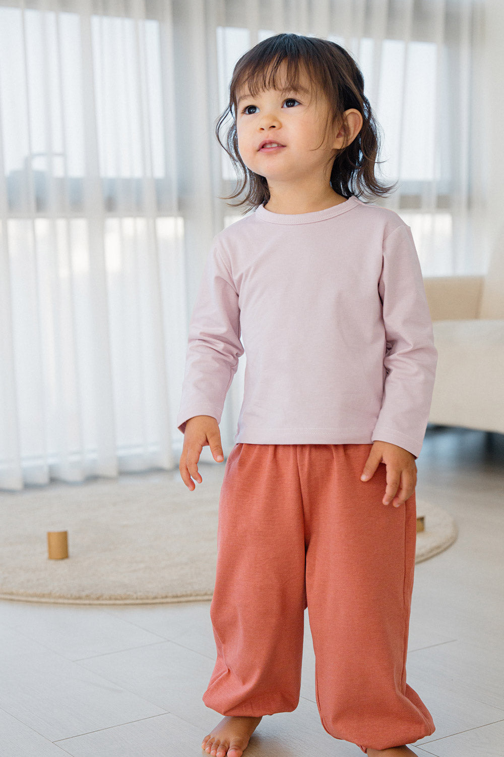 Toddler girl wearing Avauma Rosy Cocoa jogger set – soft long sleeve top and jogger pants
 Toddler girl wearing Avauma Rosy Cocoa jogger set – soft long sleeve top and jogger pants