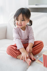 Toddler girl smiling in Avauma Rosy Cocoa jogger set – soft cotton loungewear for baby girls
 Toddler girl smiling in Avauma Rosy Cocoa jogger set – soft cotton loungewear for baby girls