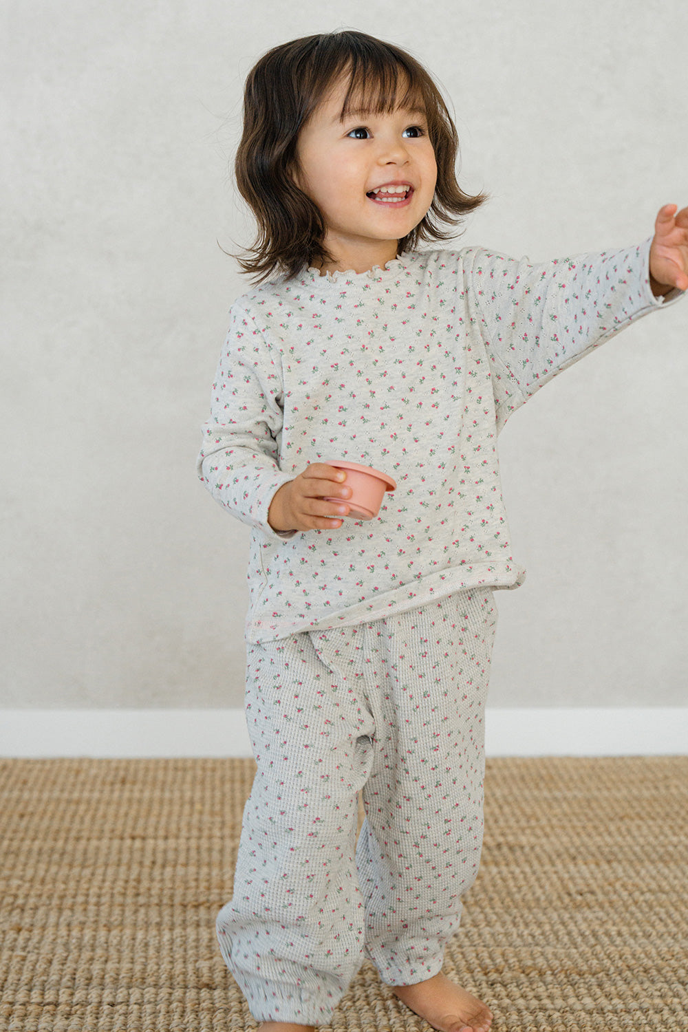 Toddler girl in Avauma Mayrose Oat pajama set – long sleeve floral top and matching pants
 Toddler girl in Avauma Mayrose Oat pajama set – long sleeve floral top and matching pants