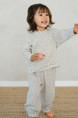 Toddler girl in Avauma Mayrose Oat pajama set – long sleeve floral top and matching pants
 Toddler girl in Avauma Mayrose Oat pajama set – long sleeve floral top and matching pants