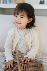 Toddler girl in Avauma Mayrose Oat pajama with a light outer layer – sweet floral baby outfit
 Toddler girl in Avauma Mayrose Oat pajama with a light outer layer – sweet floral baby outfit