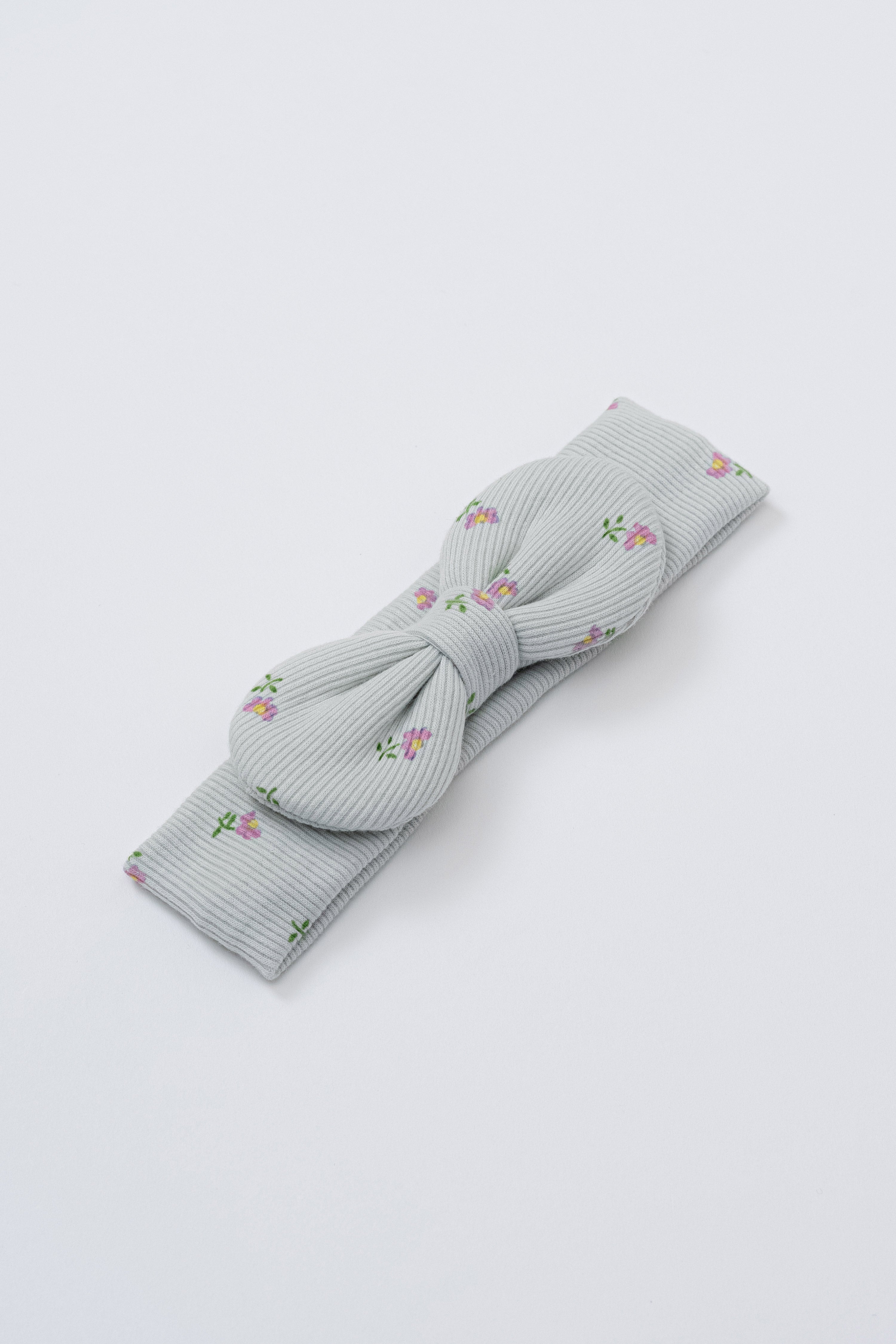 Avauma Lovely Bloom Headband in Mint Rose, with light gray ribbed fabric and delicate pink floral embroidery, tied in a bow Avauma Lovely Bloom Headband in Mint Rose, with light gray ribbed fabric and delicate pink floral embroidery, tied in a bow