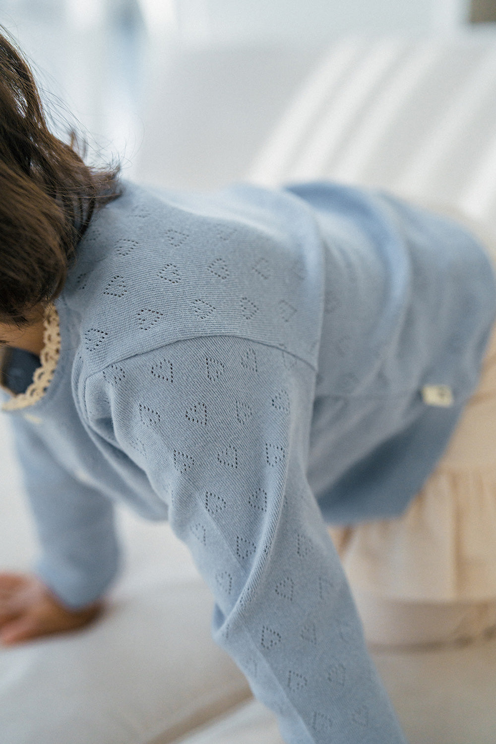 Close-up of Avauma Lovely Breeze Henley Shirt – Delicate pointelle pattern and soft fabric for babies Close-up of Avauma Lovely Breeze Henley Shirt – Delicate pointelle pattern and soft fabric for babies