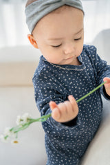 Newborn girl wearing Avauma Ocean Fleur baby pajama – soft and comfy navy floral set
 Newborn girl wearing Avauma Ocean Fleur baby pajama – soft and comfy navy floral set