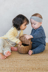 Two baby girls wearing Avauma pajamas – Ocean Fleur and Sky Blossom floral baby sleepwear
 Two baby girls wearing Avauma pajamas – Ocean Fleur and Sky Blossom floral baby sleepwear