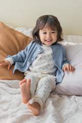 Baby girl smiling in Avauma Sky Blossom pajama – soft floral sleepwear for toddlers
 Baby girl smiling in Avauma Sky Blossom pajama – soft floral sleepwear for toddlers