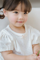 Close-up of Avauma Merry Purp Vanilla Cream Short Sleeve Top, Soft Cotton Fabric with Delicate Puff Sleeves
Close-up of Avauma Merry Purp Vanilla Cream Short Sleeve Top, Soft Cotton Fabric with Delicate Puff Sleeves
