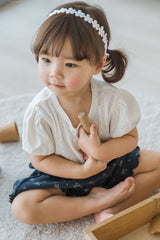 Toddler Sitting Calmly in Avauma Merry Purp Vanilla Cream Short Sleeve Top, Cozy and Stylish Babywear
Toddler Sitting Calmly in Avauma Merry Purp Vanilla Cream Short Sleeve Top, Cozy and Stylish Babywear