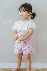 Standing Toddler Wearing Avauma Merry Purp Vanilla Cream Puff Sleeve T-Shirt, Matched with Pink Shorts
Standing Toddler Wearing Avauma Merry Purp Vanilla Cream Puff Sleeve T-Shirt, Matched with Pink Shorts