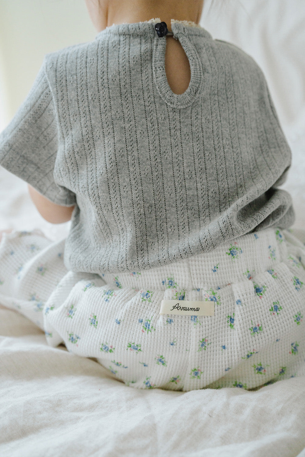 Back Detail of Toddler in Avauma Petit Bloom Blooming White Shorts, Elastic Waist Ribbed Shorts with Small Flowers
Back Detail of Toddler in Avauma Petit Bloom Blooming White Shorts, Elastic Waist Ribbed Shorts with Small Flowers