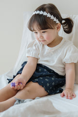 Baby Girl in Avauma Petit Bloom Deep Blue Flower Shorts, Navy Ribbed Cotton Shorts with Tiny White Blossoms
Baby Girl in Avauma Petit Bloom Deep Blue Flower Shorts, Navy Ribbed Cotton Shorts with Tiny White Blossoms
