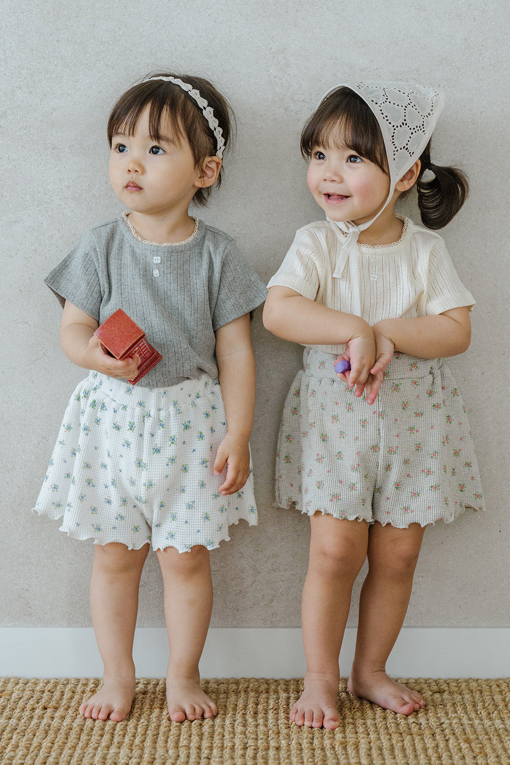 Two Toddler Girls in Avauma Petit Bloom Rosy Cream Baby Shorts, Matching Summer Outfits with Vintage Floral Print
Two Toddler Girls in Avauma Petit Bloom Rosy Cream Baby Shorts, Matching Summer Outfits with Vintage Floral Print