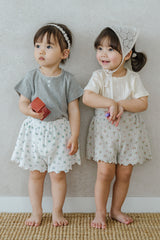 Two Toddler Girls in Avauma Petit Bloom Rosy Cream Baby Shorts, Matching Summer Outfits with Vintage Floral Print
Two Toddler Girls in Avauma Petit Bloom Rosy Cream Baby Shorts, Matching Summer Outfits with Vintage Floral Print