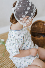 Back view of baby girl in Avauma Petit Ruffle Bluebell set, showing ruffled sleeves and blue floral pattern.
Back view of baby girl in Avauma Petit Ruffle Bluebell set, showing ruffled sleeves and blue floral pattern.