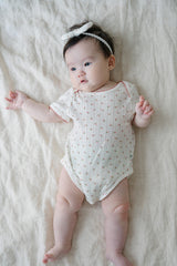 Baby Lying Down in Avauma Petite Garden Rosegarden Short Sleeve Ribbed Bodysuit, Pink Flower Pattern
 Baby Lying Down in Avauma Petite Garden Rosegarden Short Sleeve Ribbed Bodysuit, Pink Flower Pattern