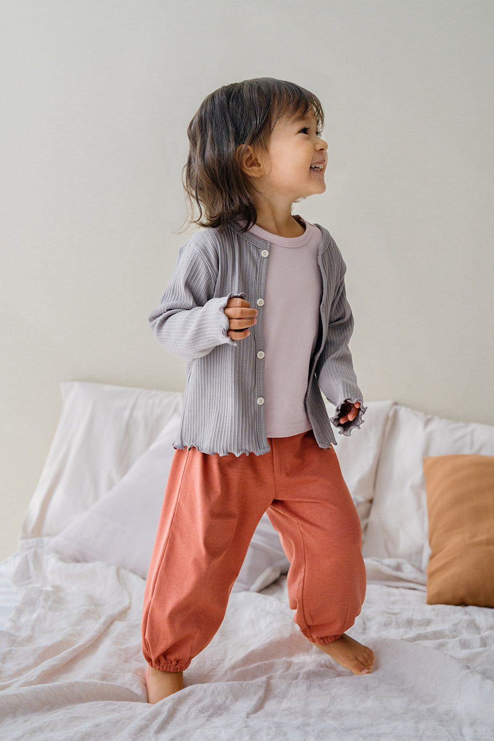 Toddler girl in Avauma ribbed cardigan and comfy pants, stylish everyday baby clothes for playtime Toddler girl in Avauma ribbed cardigan and comfy pants, stylish everyday baby clothes for playtime