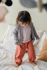 Toddler wearing Avauma Ash Beige ribbed cardigan and soft loungewear set, cozy baby outfit Toddler wearing Avauma Ash Beige ribbed cardigan and soft loungewear set, cozy baby outfit